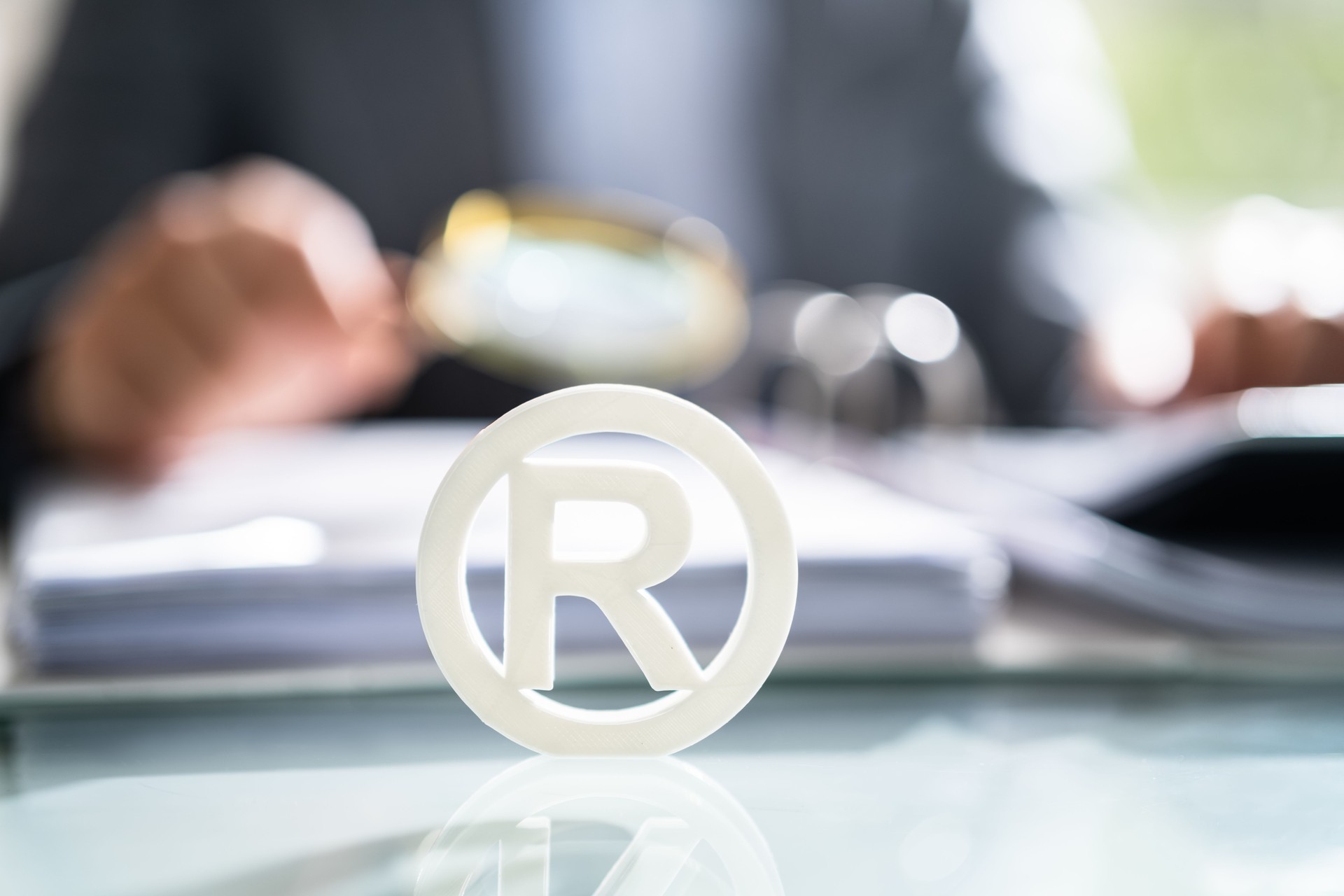 White Registered Trademark Sign Near Documents